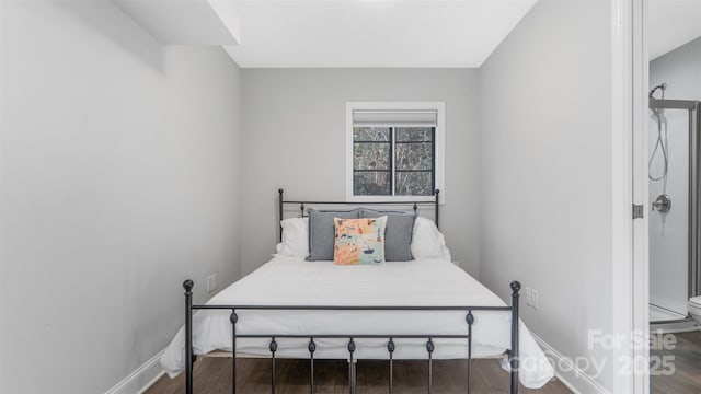 bedroom with dark hardwood / wood-style flooring