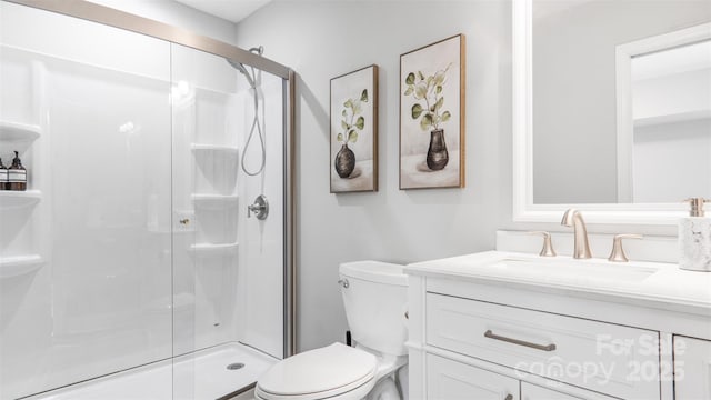 bathroom with vanity, toilet, and a shower with door