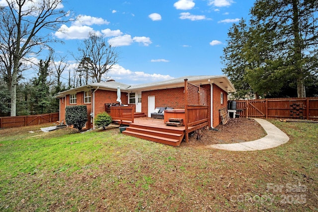 rear view of property featuring a yard and a wooden deck