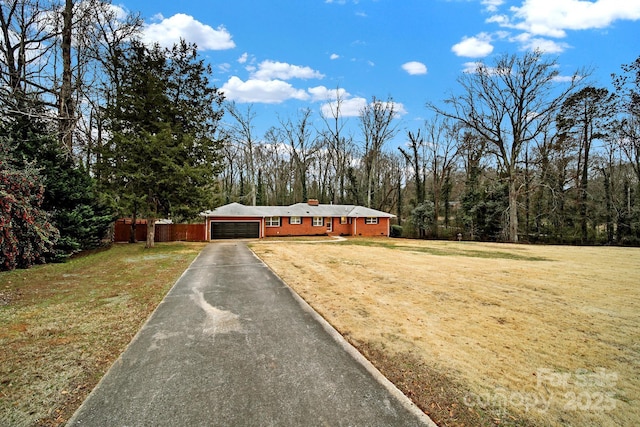 view of front facade with a front lawn and a garage