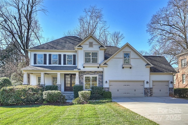 craftsman inspired home with a front lawn and a garage