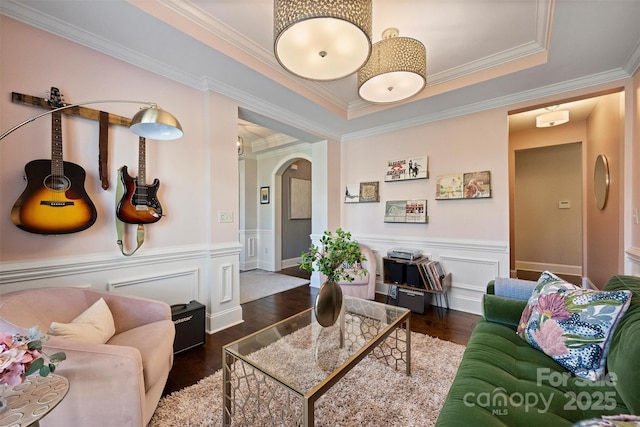 living room with crown molding and dark hardwood / wood-style flooring