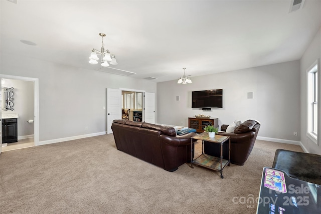 living room with light colored carpet and a notable chandelier