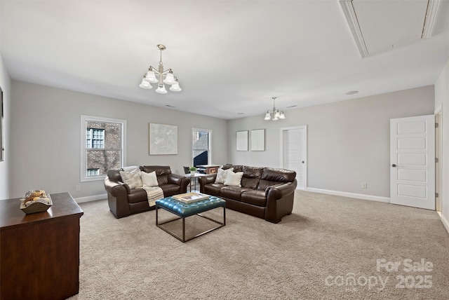 carpeted living room featuring a notable chandelier