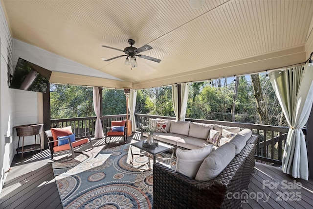 sunroom featuring lofted ceiling, ceiling fan, and a healthy amount of sunlight