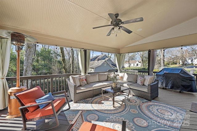 sunroom / solarium with ceiling fan and lofted ceiling