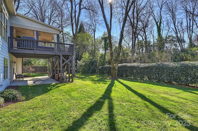 view of yard with a patio area and a wooden deck