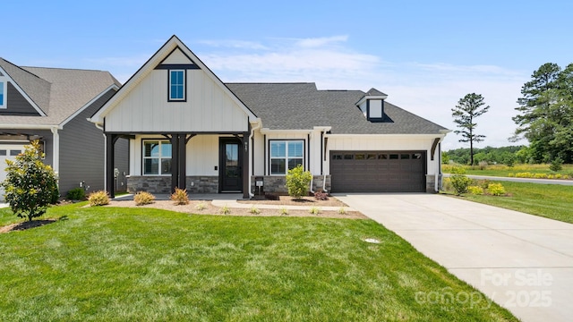 view of front of property featuring a garage and a front lawn