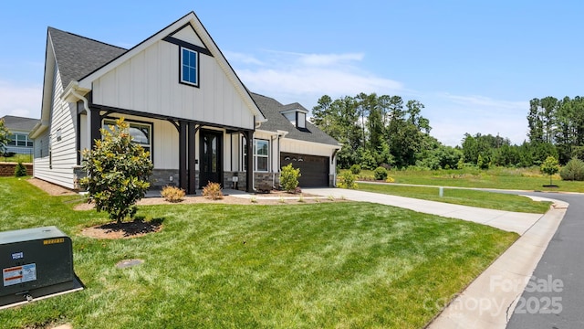 view of front of house featuring a garage and a front lawn