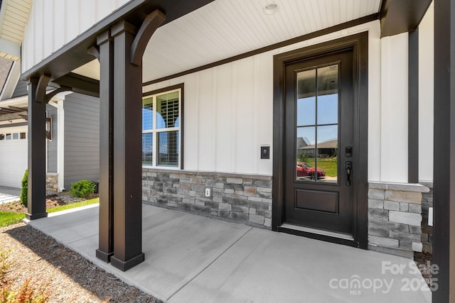 entrance to property with a porch and a garage