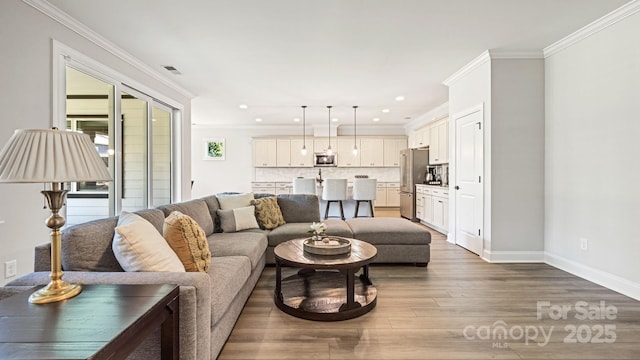 living room featuring hardwood / wood-style flooring and ornamental molding