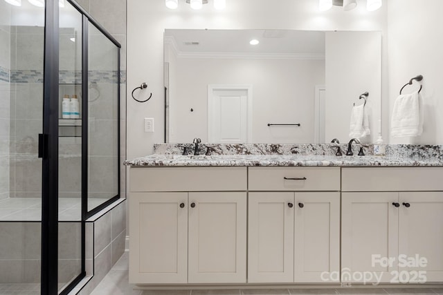 bathroom featuring vanity, ornamental molding, and walk in shower