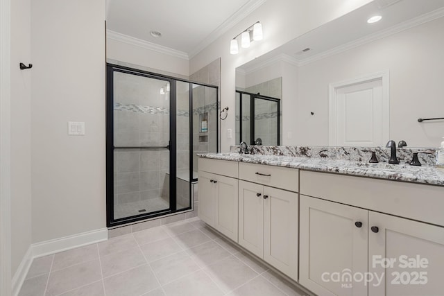 bathroom with tile patterned floors, vanity, crown molding, and walk in shower