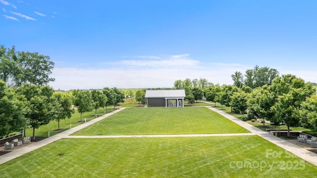 view of community featuring a lawn and an outbuilding