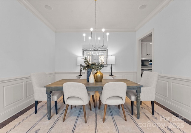 dining space featuring a notable chandelier and crown molding