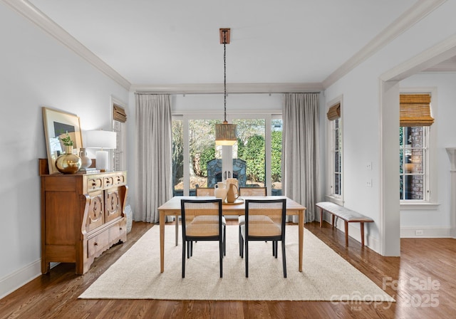 dining area featuring ornamental molding and hardwood / wood-style floors