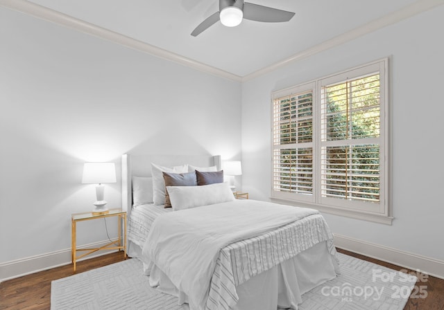 bedroom featuring crown molding, dark hardwood / wood-style floors, and ceiling fan