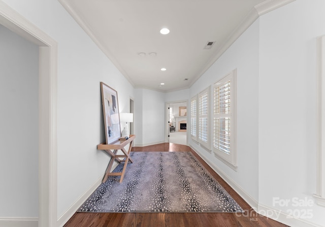 hall featuring crown molding and wood-type flooring