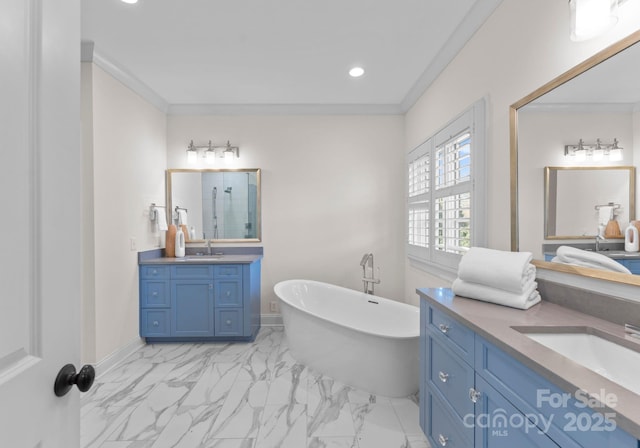 bathroom featuring vanity, crown molding, and a tub