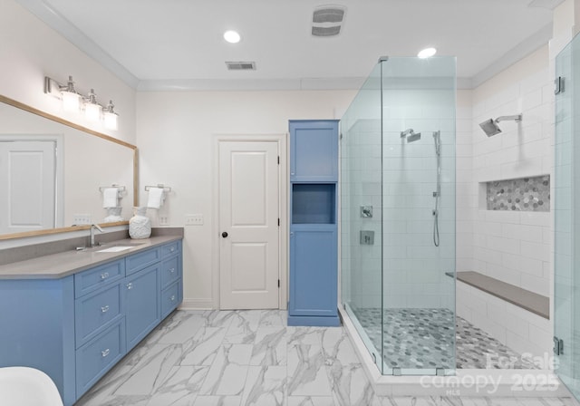 bathroom with vanity, crown molding, and a shower with door