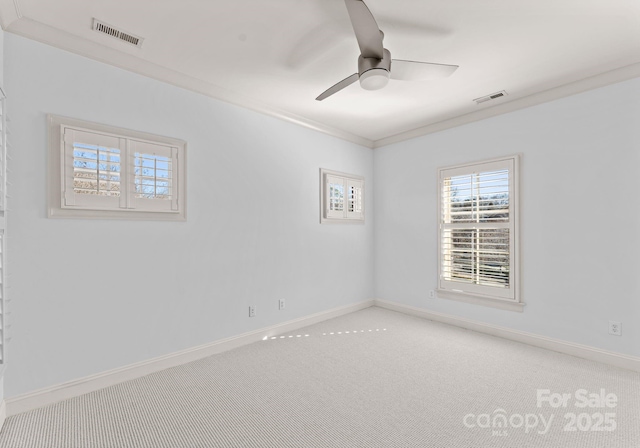 carpeted empty room featuring crown molding and ceiling fan