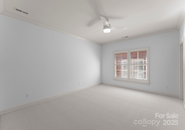 unfurnished room featuring light carpet, crown molding, and ceiling fan