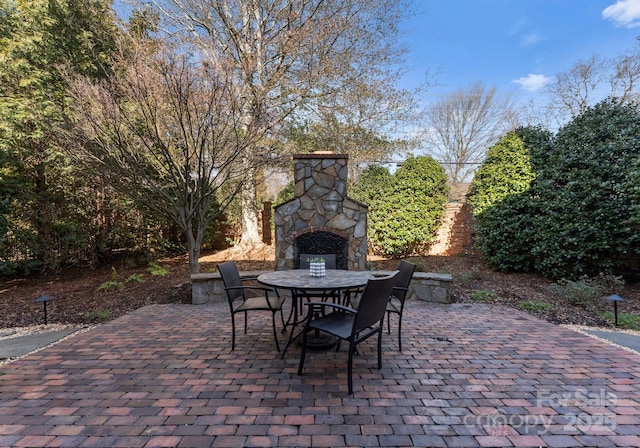 view of patio with an outdoor stone fireplace