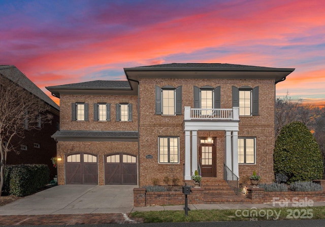 view of front of home with a garage and a balcony