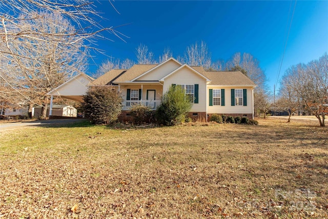 single story home featuring a carport, a porch, and a front yard