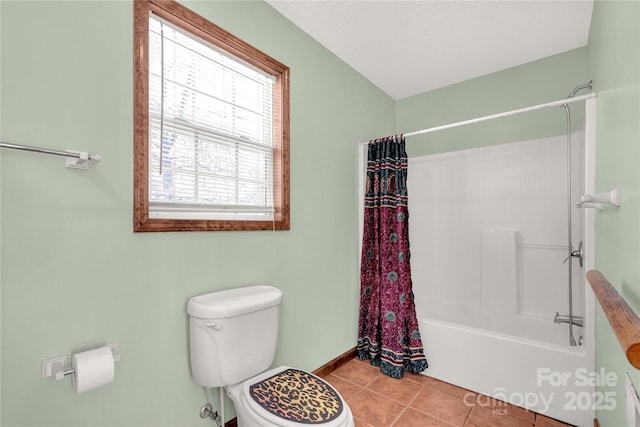 bathroom with tile patterned floors, plenty of natural light, toilet, and shower / bath combo with shower curtain