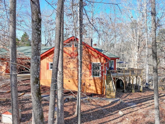 view of side of property featuring a wooden deck