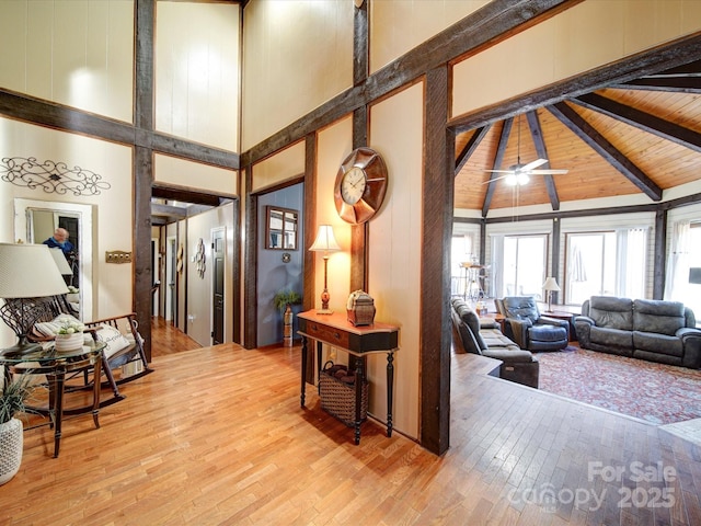 hall featuring wood ceiling, beam ceiling, wood-type flooring, and high vaulted ceiling