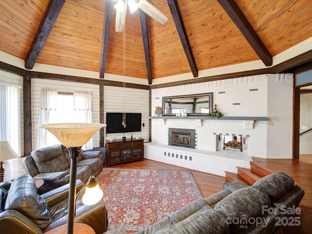 living room with beamed ceiling, wood ceiling, and hardwood / wood-style flooring