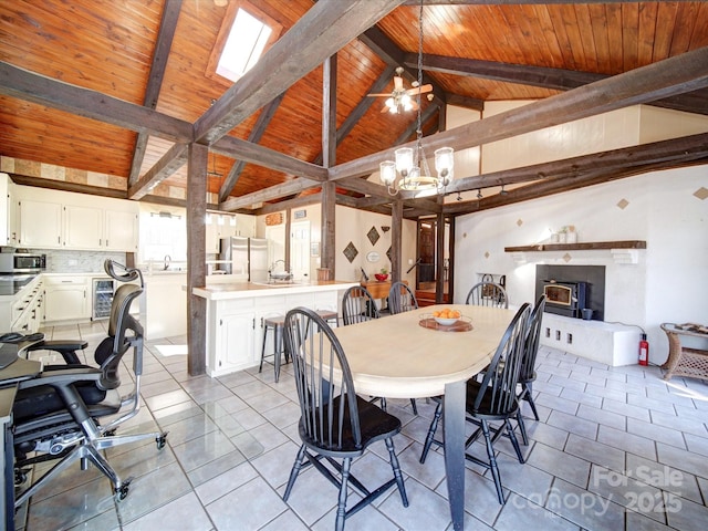 tiled dining space featuring beam ceiling, beverage cooler, high vaulted ceiling, wood ceiling, and ceiling fan with notable chandelier