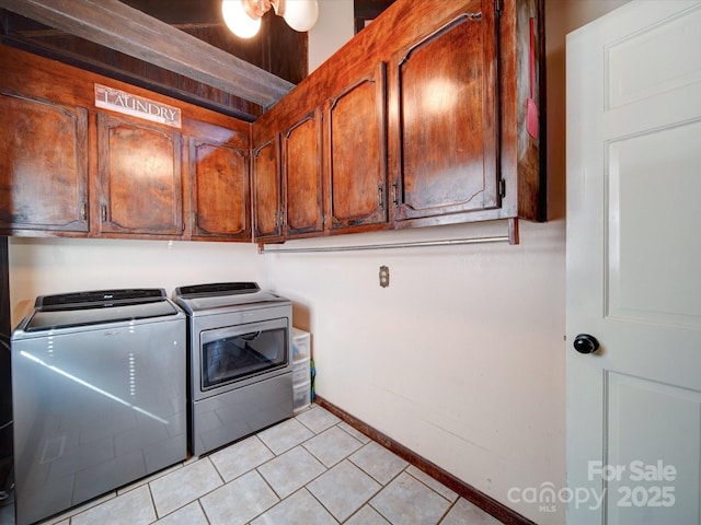 washroom featuring light tile patterned flooring, cabinets, and independent washer and dryer