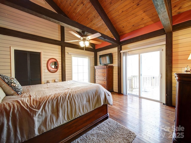 bedroom featuring hardwood / wood-style floors, access to outside, wooden walls, vaulted ceiling with beams, and wood ceiling