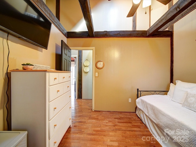 bedroom with vaulted ceiling with beams, light hardwood / wood-style flooring, and ceiling fan