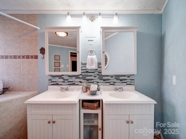 bathroom featuring backsplash, crown molding, and vanity