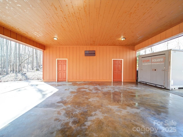 garage featuring wood walls