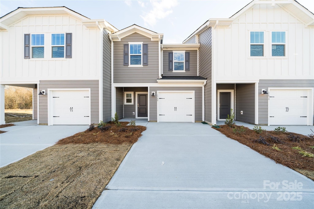 view of front of property featuring a garage, driveway, and board and batten siding