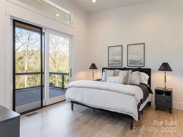 bedroom with access to outside and light wood-type flooring