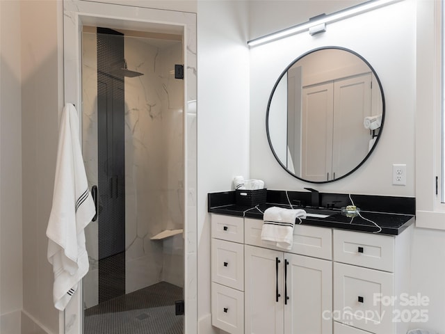 bathroom featuring vanity and a shower with shower door