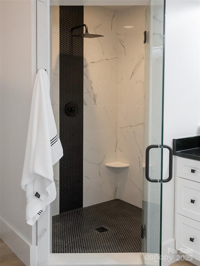 bathroom with vanity and a shower with door