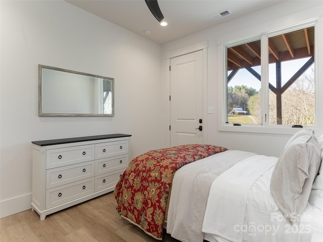 bedroom with ceiling fan and light hardwood / wood-style floors