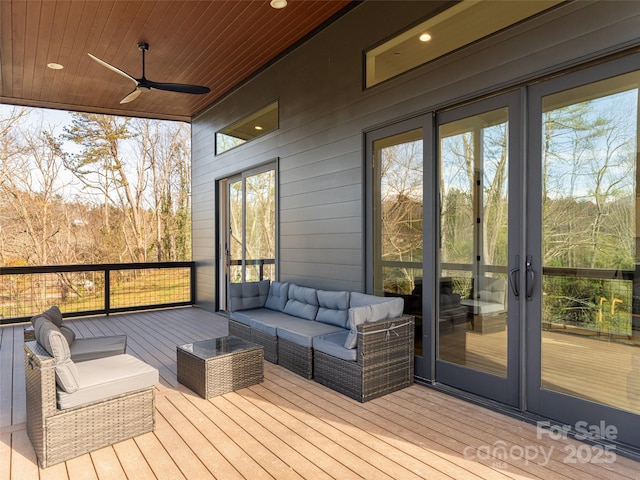 wooden terrace with ceiling fan and french doors