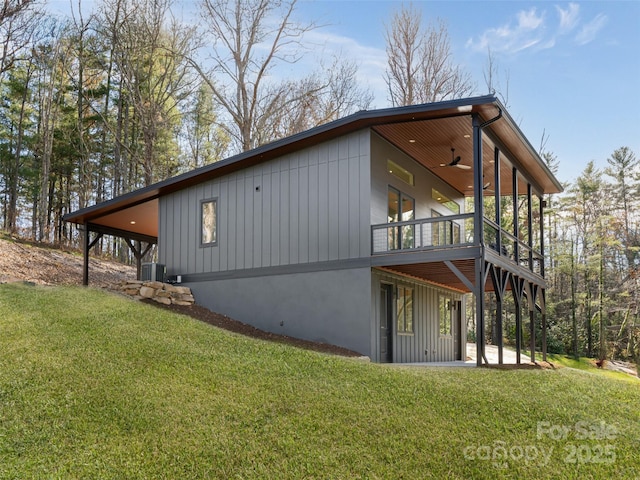 view of side of home with a patio, cooling unit, and a lawn