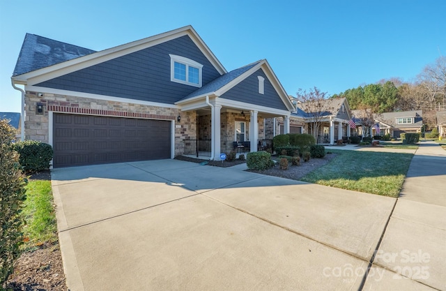 view of front of property with covered porch and a garage