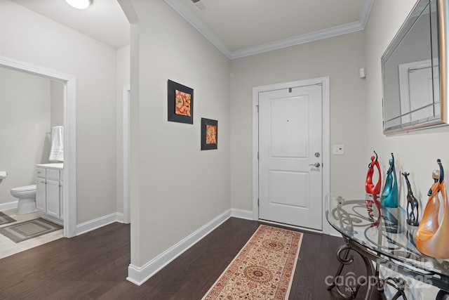 foyer with crown molding and dark wood-type flooring