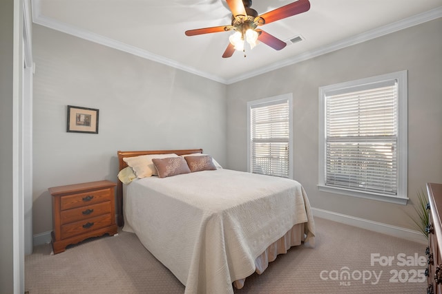 carpeted bedroom with ceiling fan and crown molding