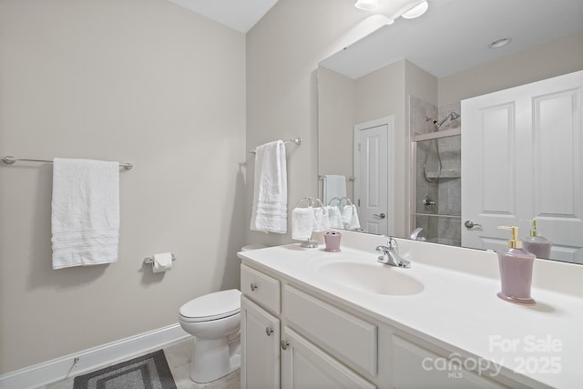 bathroom featuring tile patterned floors, vanity, toilet, and a shower with shower door